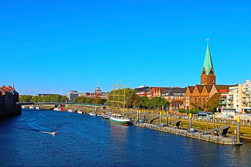 Riverfront of river Weser with ship and Martini church in Bremen, northern