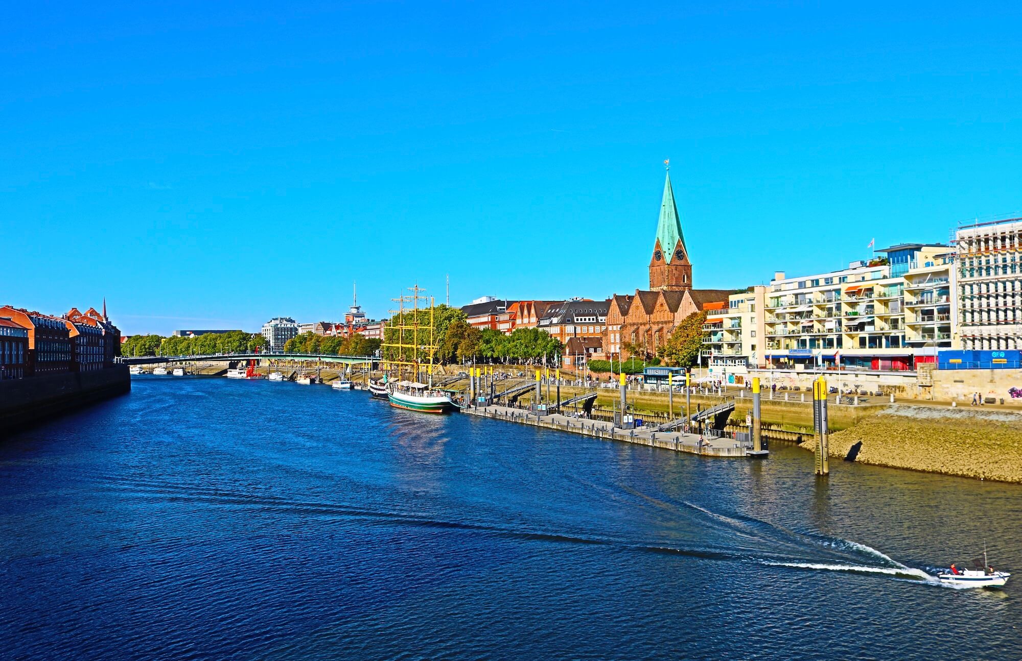 Riverfront of river Weser with ship and Martini church in Bremen, northern