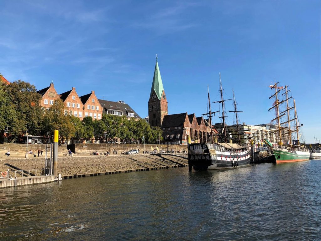 Riverfront of river Weser with ships and Martini church in Bremen, northern