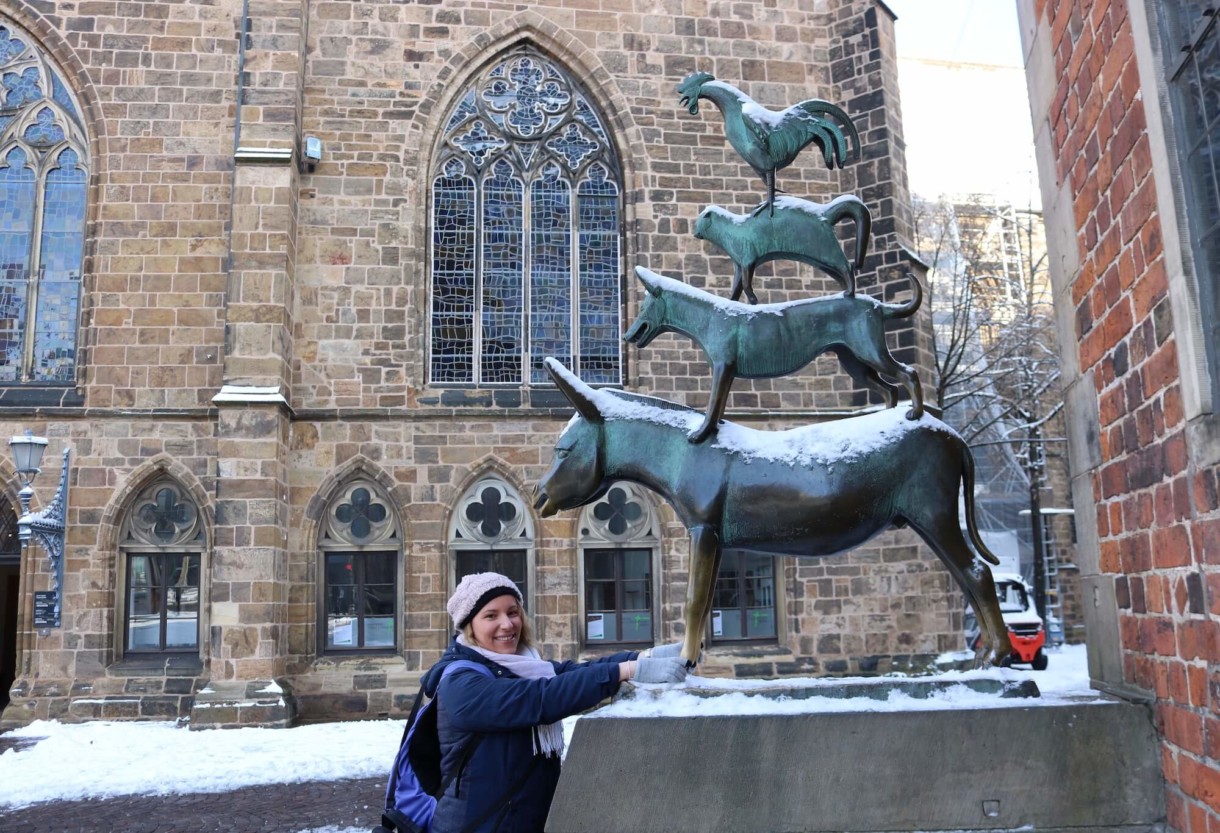 Tour guide Sonja Irani at the statue of the Bremen Town Musicians in Bremen, northern Germany