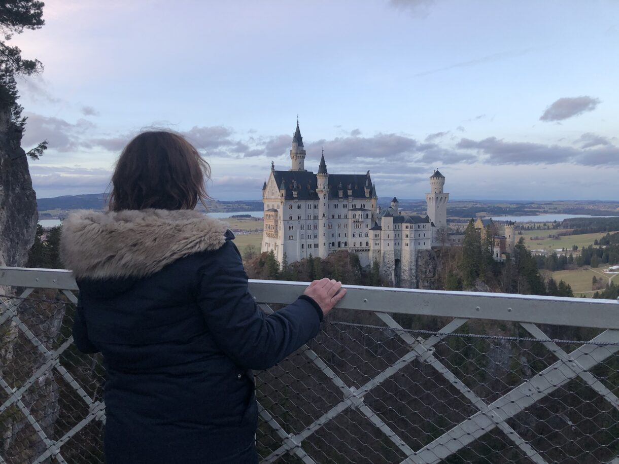Tour guide Sonja Irani looking at Neuschwanstein Castle from the Marienbrücke in January