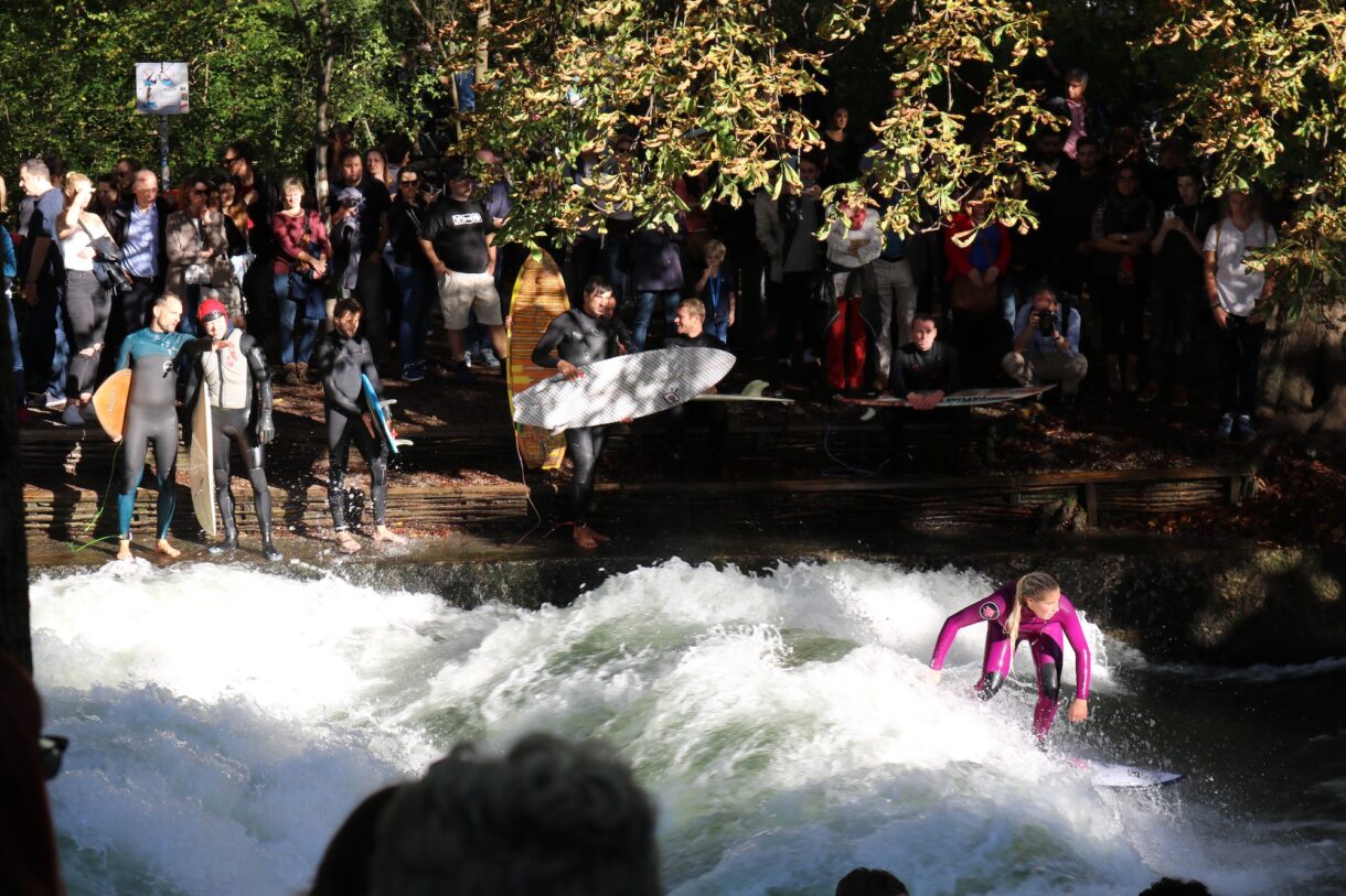 Surfers at the "Eisbach wave" in the English Garden