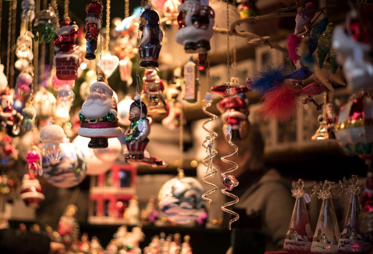 Colorful handmade Christmas ornaments hanging at a stall in a traditional Christmas market. Photo: Envato Elements.